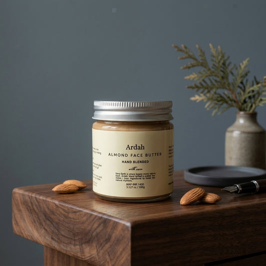 Jar of Ardah Almond Face Butter on a wooden surface with almonds and a plant in the background.